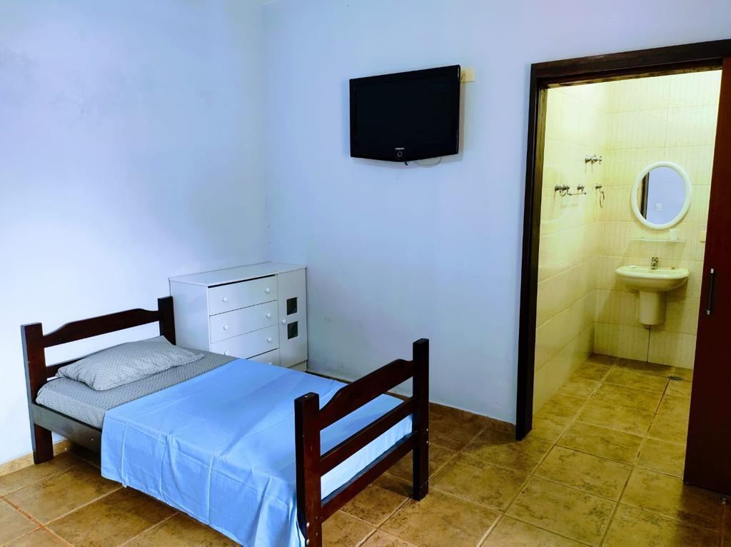 Quarto individual com televisão e banheiro privativo